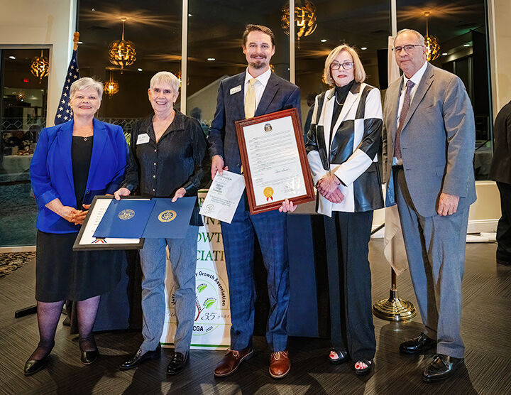 Dr. Julia Hampton and Blake Tilley of the Jefferson College Foundation receive the foundation's awards.